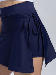 Dark blue wrap-detail skort with side tie closure and a flared hem.