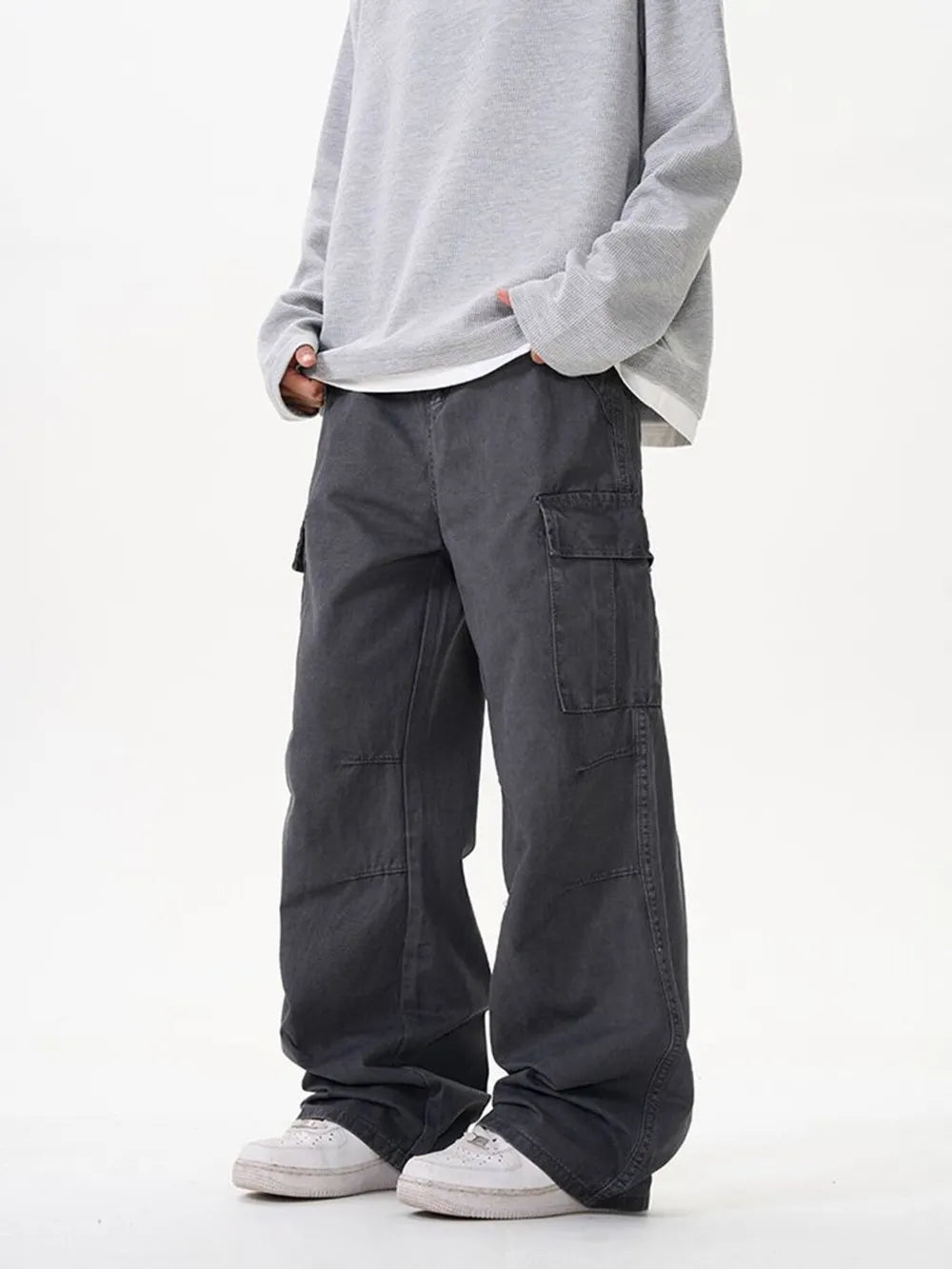 Grey cargo pants with versatile pockets and a relaxed fit.