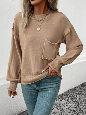 Camel knit sweater with raglan sleeves, a chest pocket, and ribbed cuffs and hem.