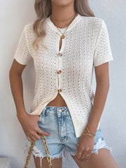 Cream knit button-up cardigan with short sleeves and open knit detail.