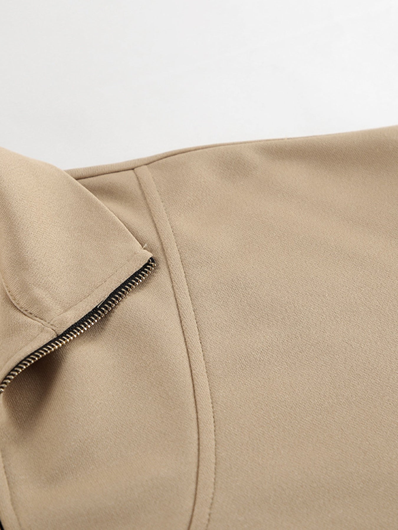 Camel quarter zip top detail with zipper and stitching