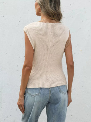 Two-tone knit vest with ribbed texture and contrast trim, styled with jeans.
