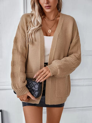 Camel chunky knit open-front cardigan with pockets and textured sleeves.