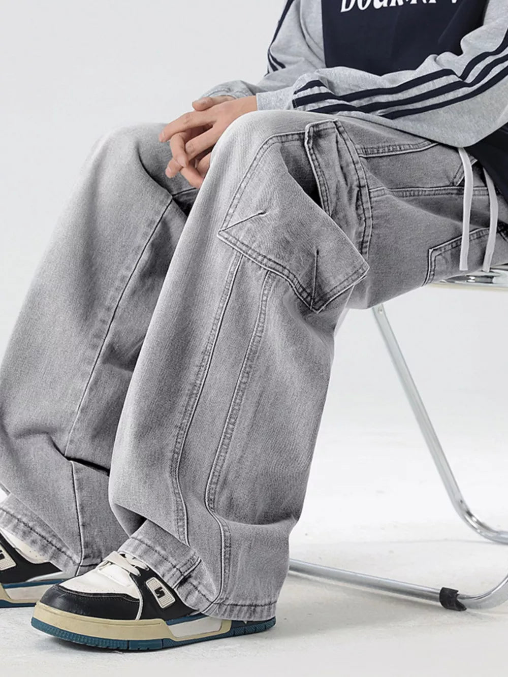 Light gray oversized cargo jeans with drawstring waist and utility pockets.