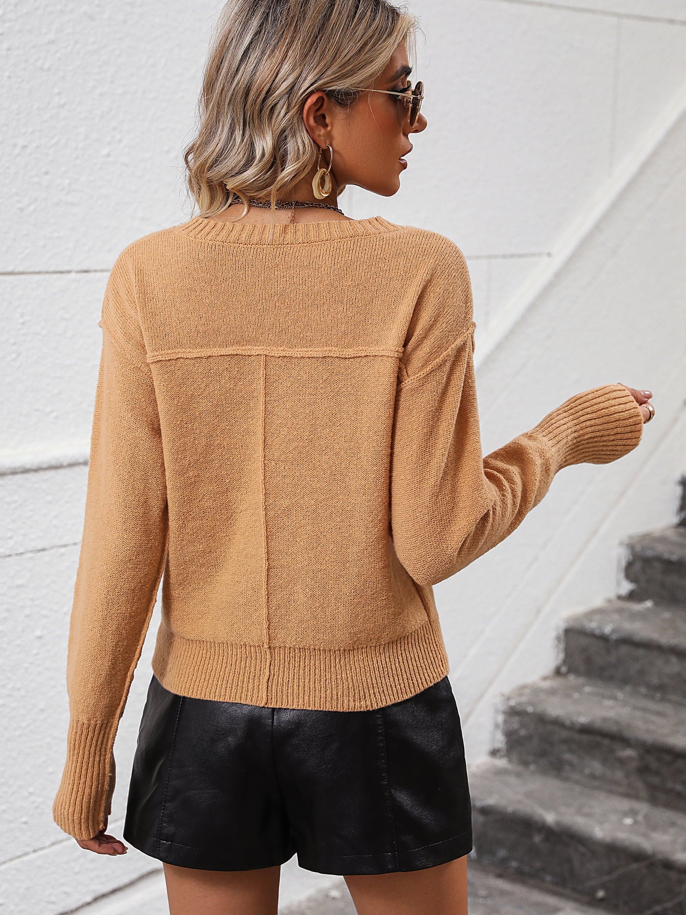 Camel V-neck knit sweater with relaxed fit and ribbed cuffs and hem.