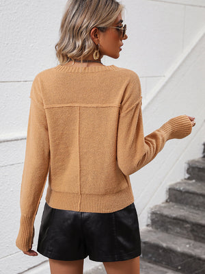 Camel V-neck knit sweater with relaxed fit and ribbed cuffs and hem.