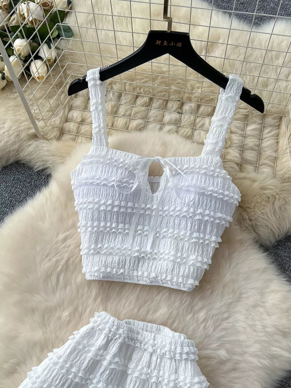 White ruched crop top with tie detail and matching mini skirt.
