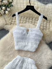 White ruched crop top with tie detail and matching mini skirt.