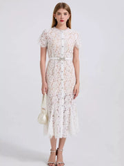 White floral lace mermaid dress with short sleeves, button front, and embellished belt.