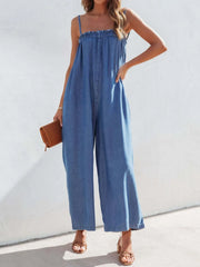 Medium denim jumpsuit with gathered bodice and wide legs.