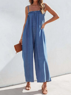 Medium denim jumpsuit with gathered bodice and wide legs.