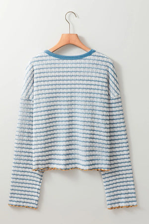 Textured stripe henley sweater in dusty blue with a crew neck and lettuce hem detail.