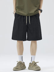 Black casual drawstring shorts with white sporty stripes and side pockets.