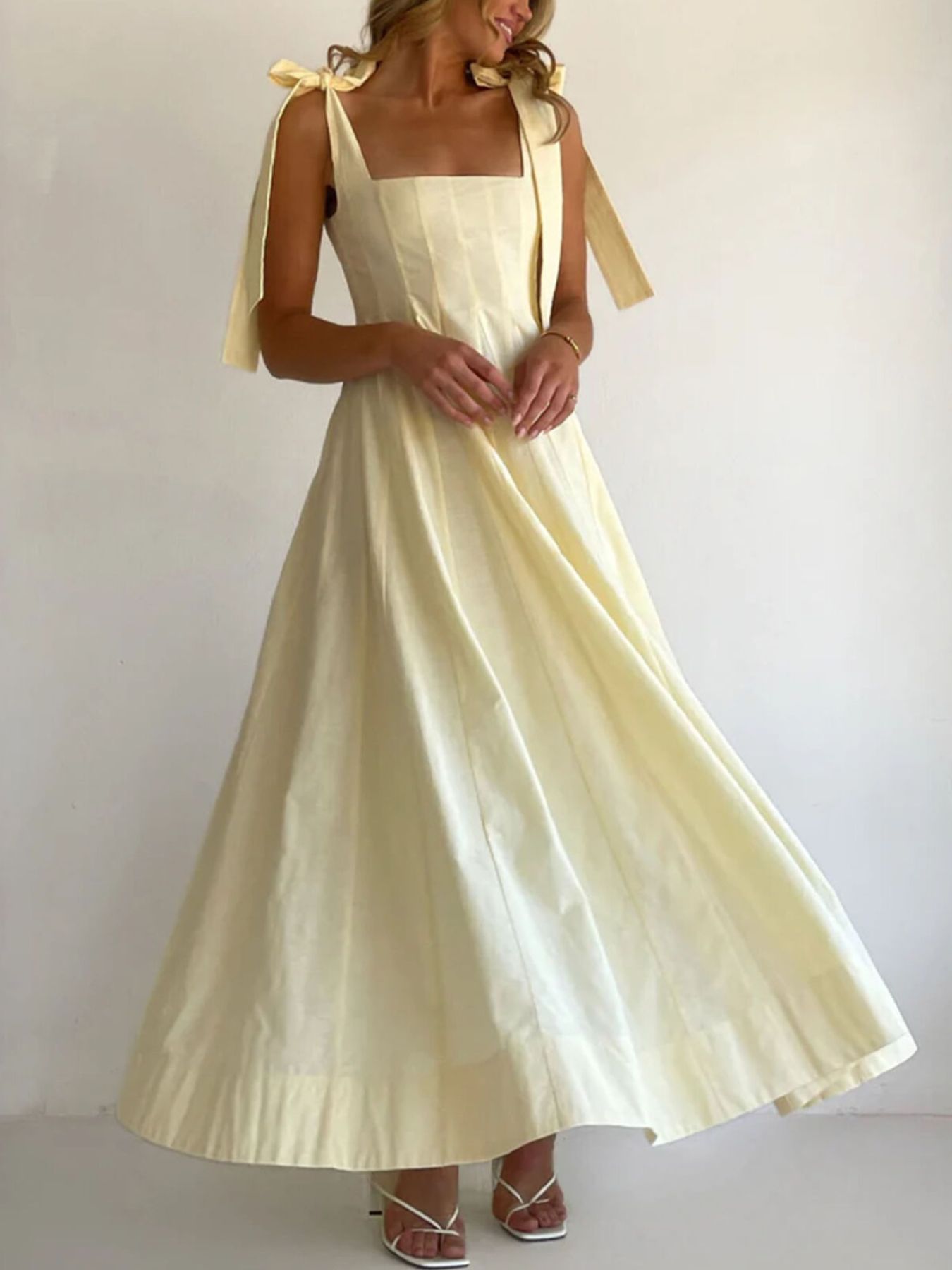 Yellow maxi dress with square neckline and bow tie shoulder straps
