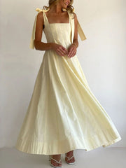 Yellow maxi dress with square neckline and bow tie shoulder straps