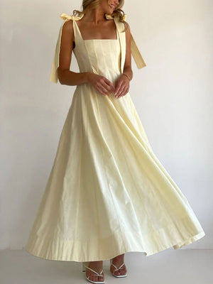 Yellow maxi dress with square neckline and bow tie shoulder straps