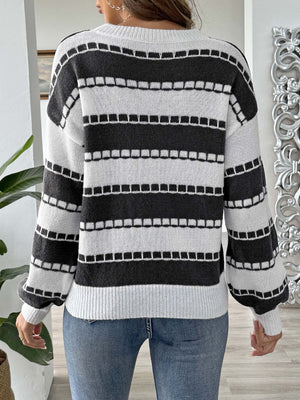 Black and white striped knit sweater with embroidered detail, crew neck, long sleeves.