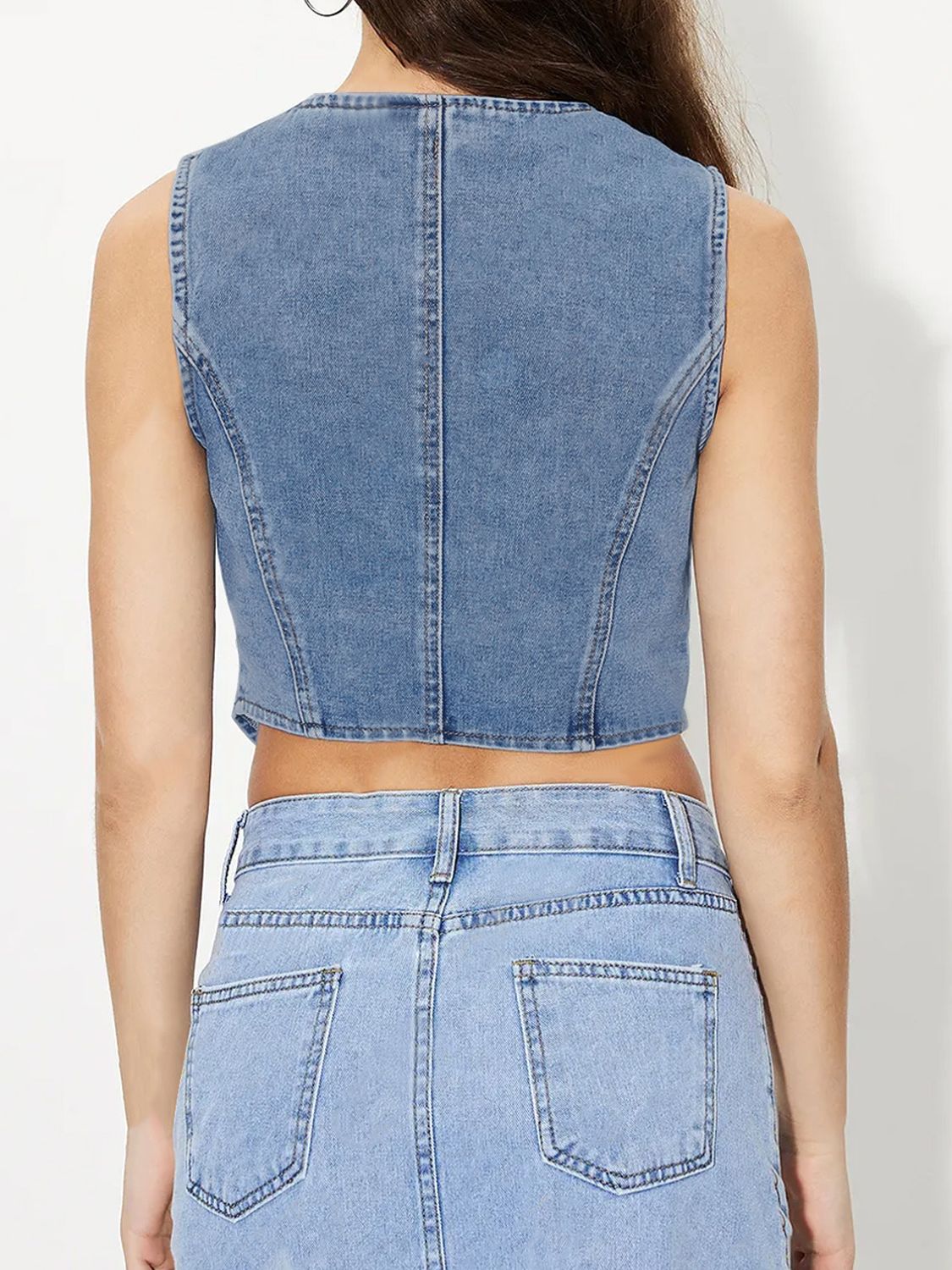 Light wash denim cropped bustier vest with button details and a fitted silhouette.