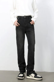 Dark wash denim jeans with asymmetric seams and a straight leg cut.