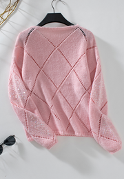 Blush pink knit sweater with diamond cutwork and sequin sleeves.