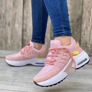 Pink lace-up chunky platform sneakers with glitter accents and gold detailing.