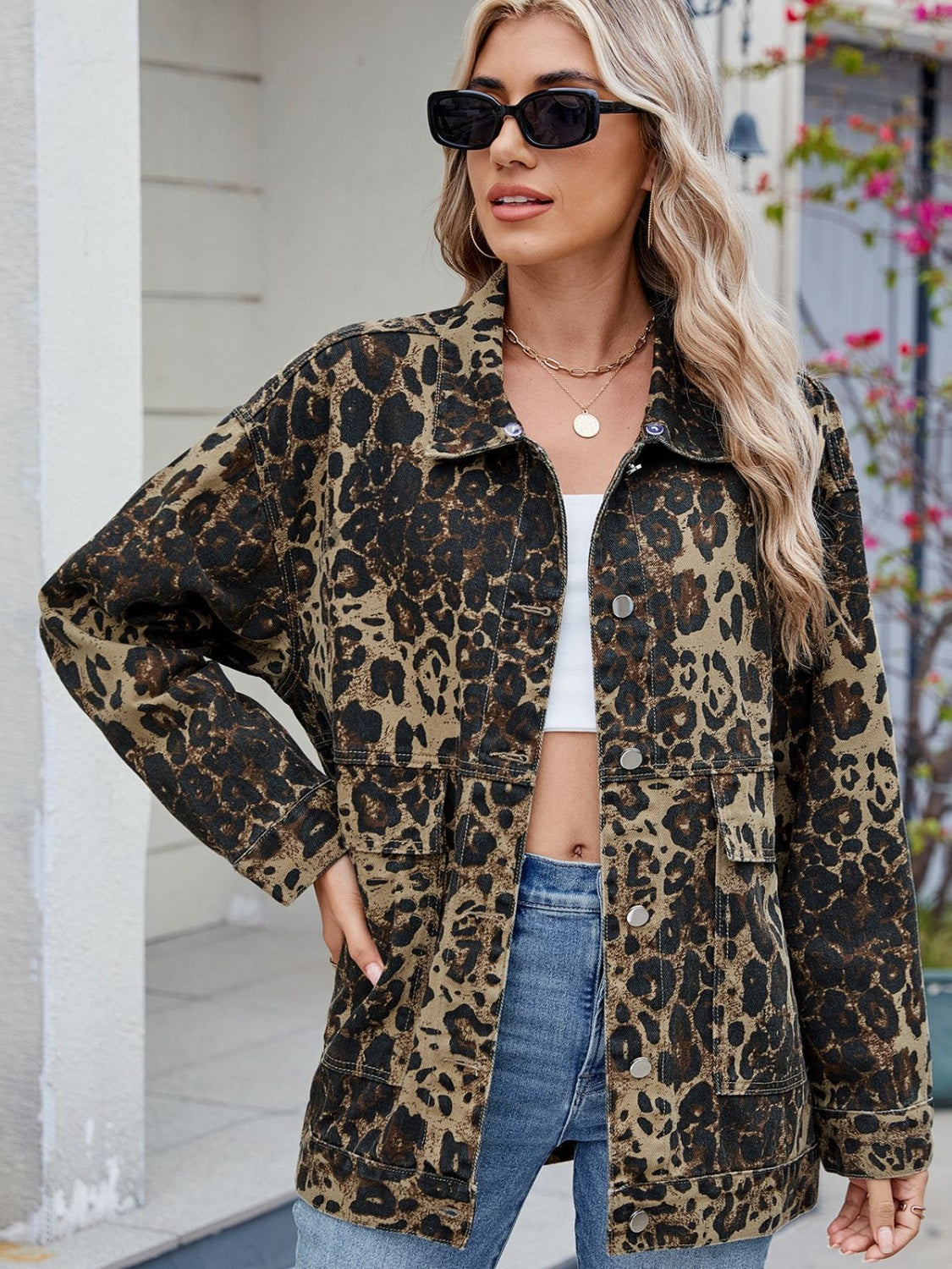 Leopard print denim utility jacket with button front and chest pockets.