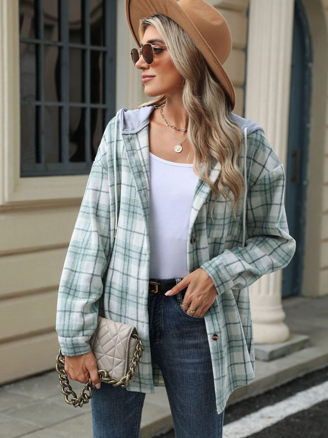 Light green plaid shacket with contrast hood and buttons, worn open over a white tank top.