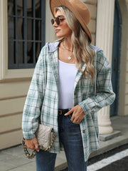 Light green plaid shacket with contrast hood and buttons, worn open over a white tank top.