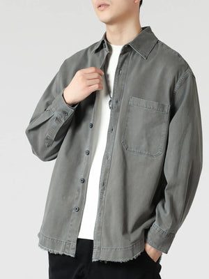 Grey oversized button-up long-sleeve shirt with frayed hem and chest pocket.
