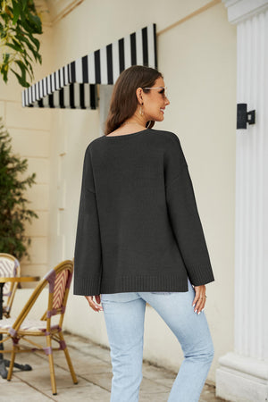 Black relaxed fit V-neck knit pullover sweater with ribbed cuffs and hem.
