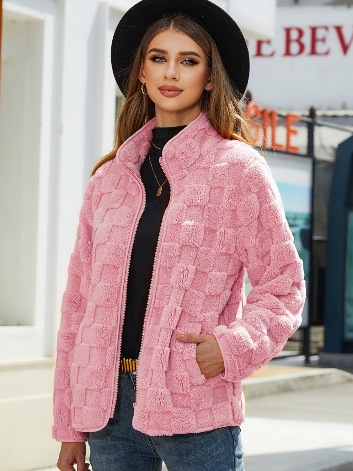 Blush pink textured grid zip-up jacket with a stand collar and side pockets.