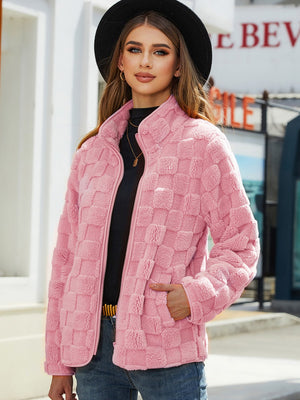 Blush pink textured grid zip-up jacket with a stand collar and side pockets.