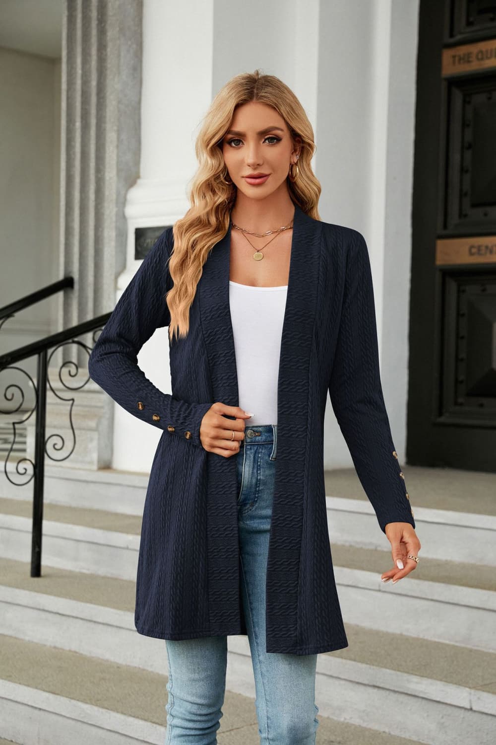 Dark blue textured knit open-front duster cardigan with gold button detail on cuffs.
