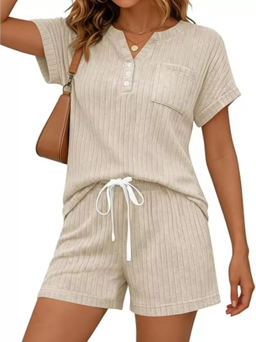 Ribbed knit loungewear set in apricot with henley neckline top and drawstring shorts.