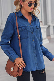 Oversized denim shirt in dark blue with patch pockets, collared neck, and buttoned front.