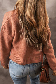 Open-front cropped knit cardigan in burnt coral acrylic with ribbed hem and cuffs.