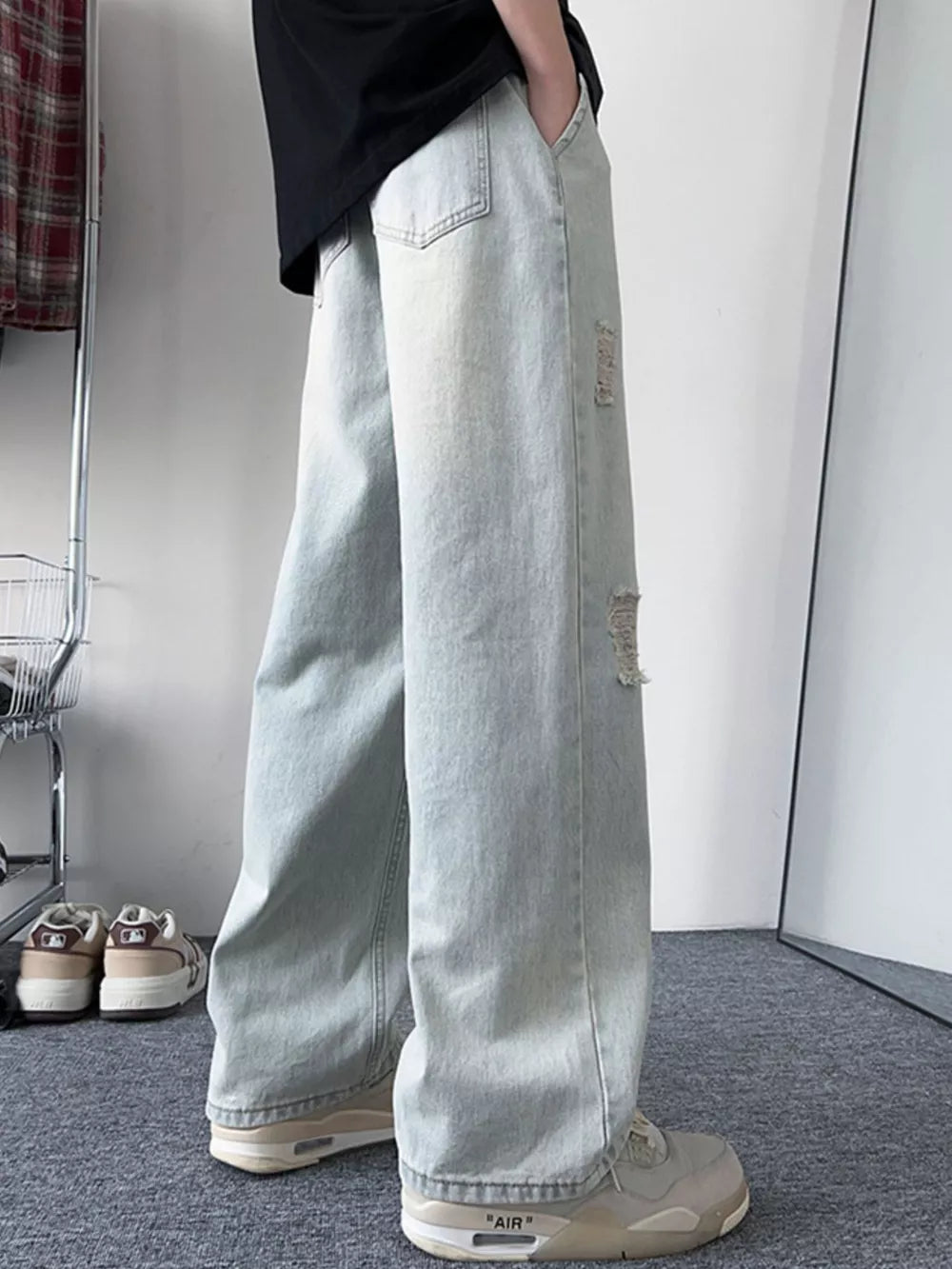 Light blue distressed wide-leg jeans with a relaxed fit.