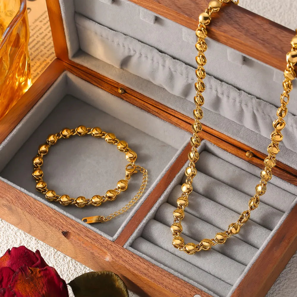 Gold 18K gold-plated bracelet with sculpted orb chain links and extender.