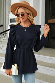 Dark blue textured peplum blouse with ruffle detail and long sleeves.