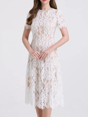 White lace midi dress with short sleeves and pearl embellishments.