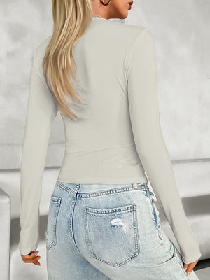 Beige long sleeve contour zip top with a high neckline, shown from the back.