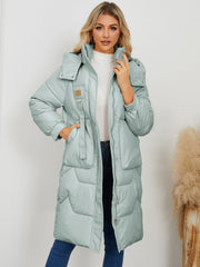 Sage quilted puffer parka with buckle detail and drawstring waist.