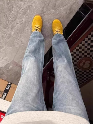 Men's light blue vintage wash straight-leg jeans with subtle vertical texture.
