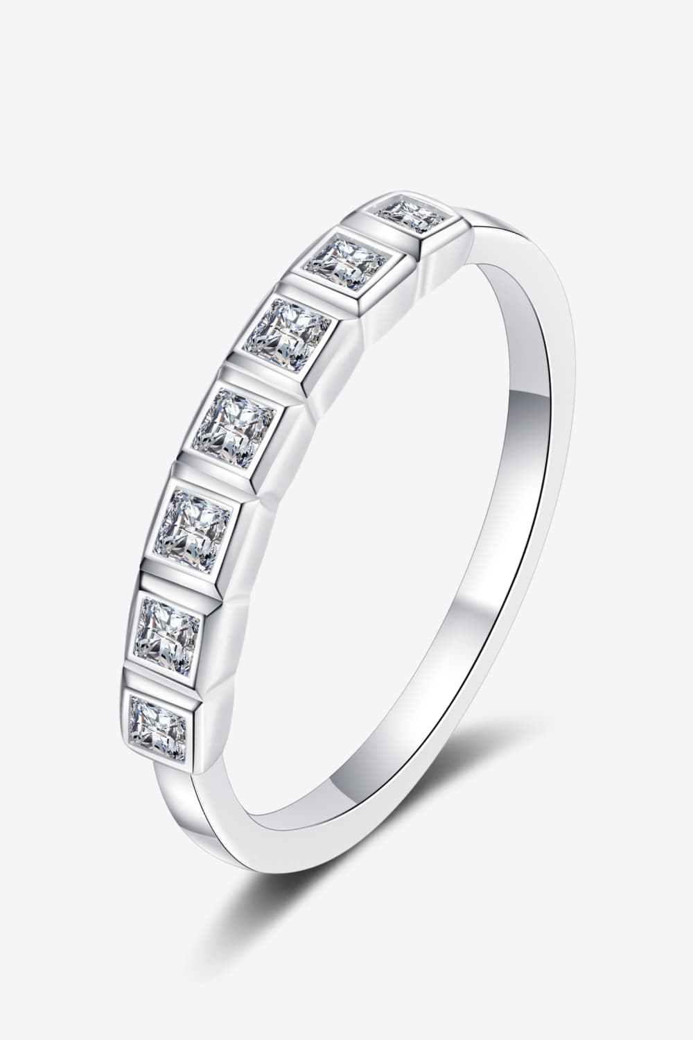 Silver band ring with princess-cut diamonds in square settings