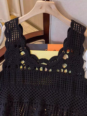Black crochet tank top with floral overlay and scalloped neckline.