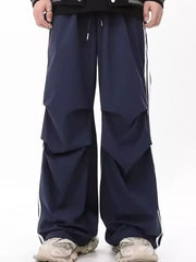 Navy wide-leg sweatpants for men with white side stripes and drawstring waist.