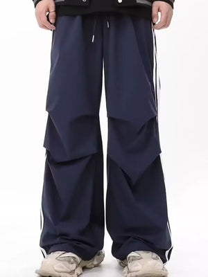 Navy wide-leg sweatpants for men with white side stripes and drawstring waist.