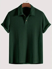 Dark green textured polo shirt with rolled sleeves and a two-button placket.