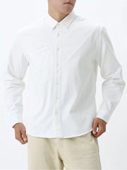 White cotton buttoned long sleeve shirt with diagonal seam detail.