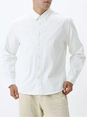 White cotton buttoned long sleeve shirt with diagonal seam detail.